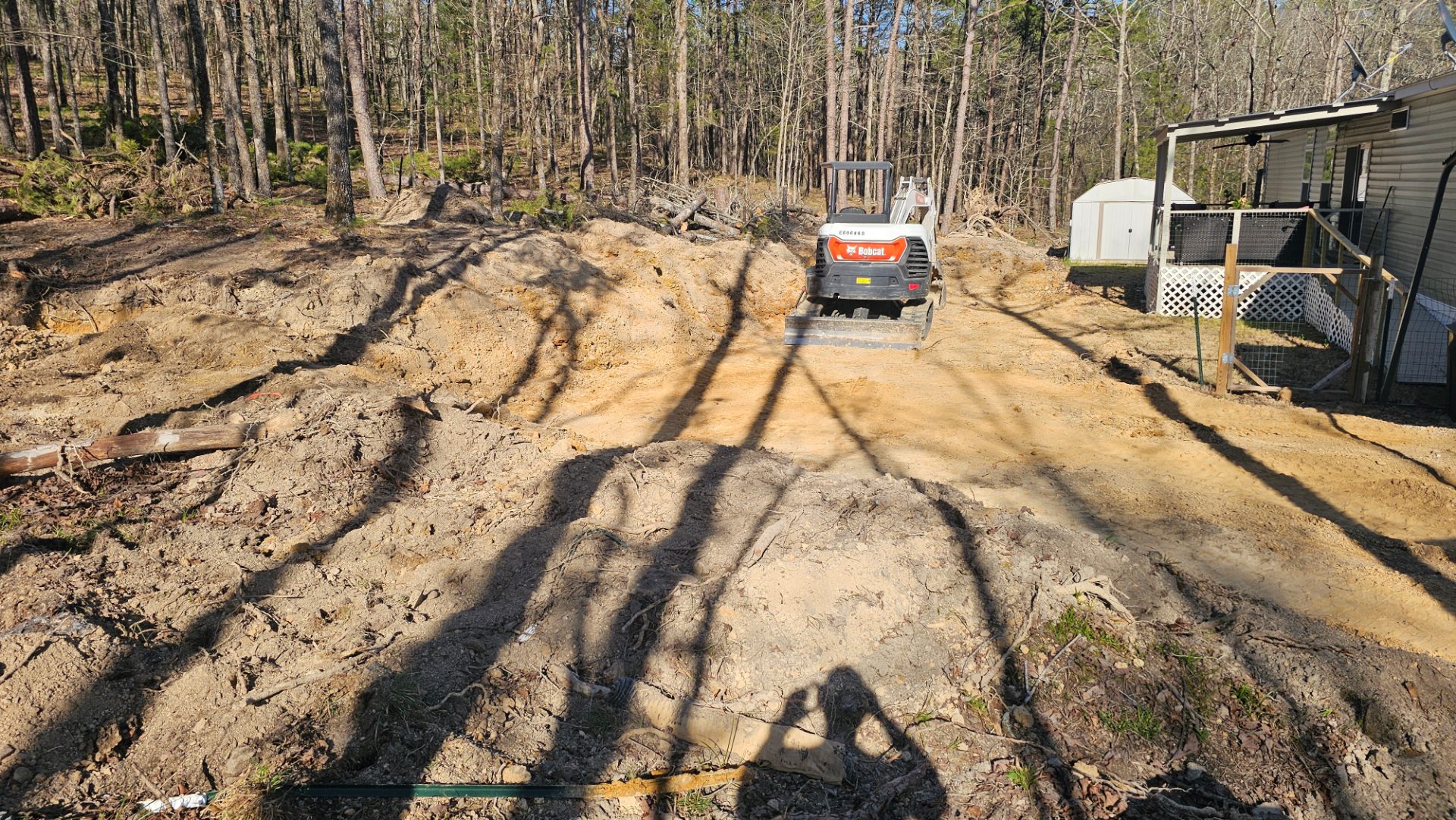 Excavator shaping a residential building pad