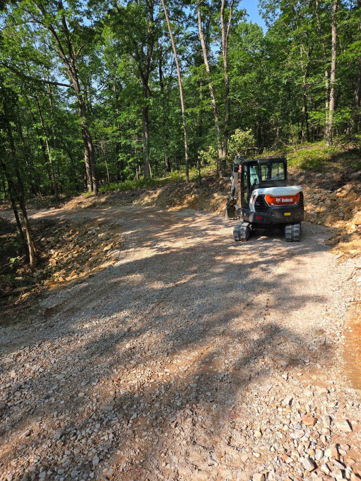 Gravel access cut through wooded hillside