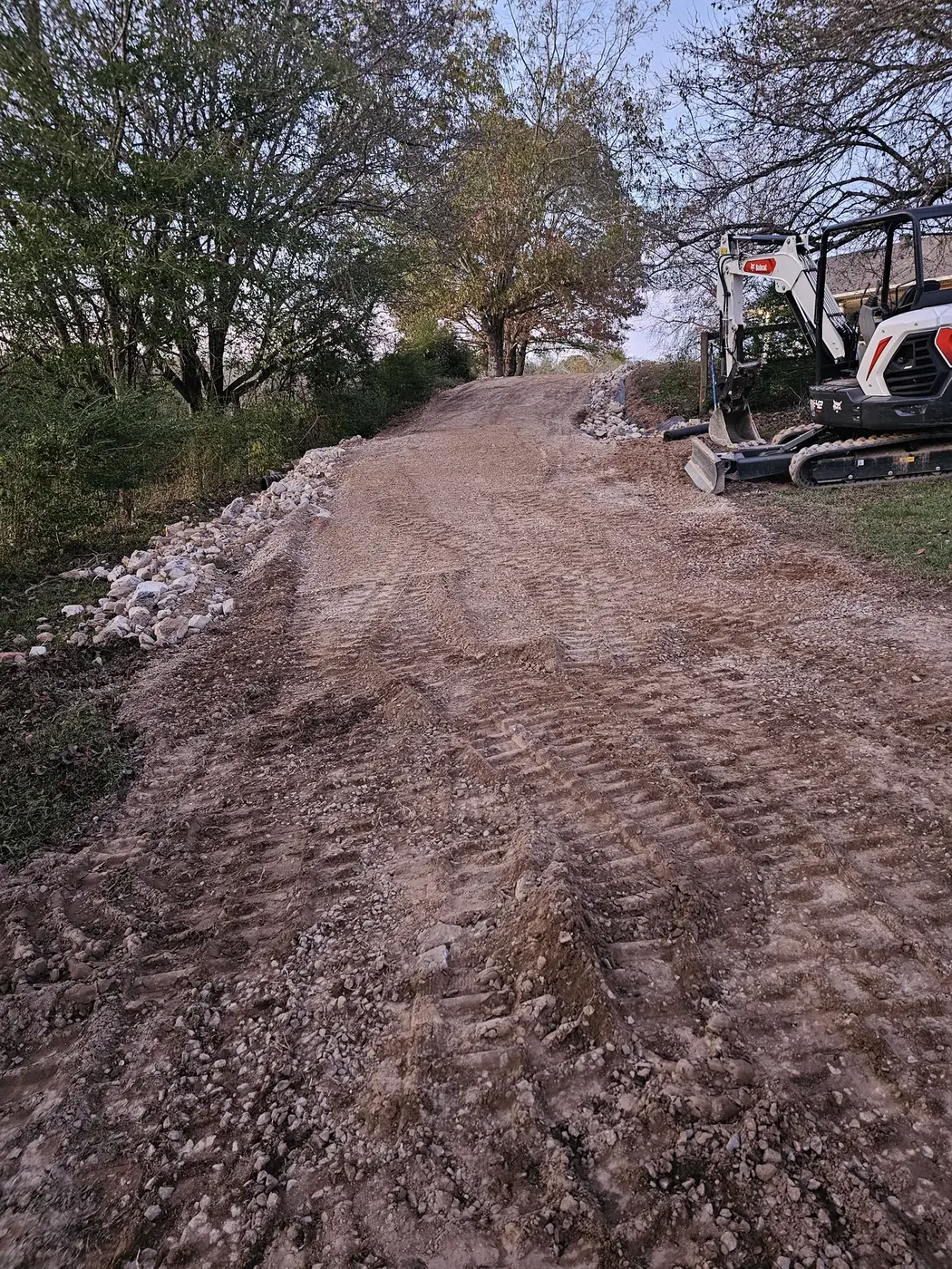 Compact equipment grading a residential access area