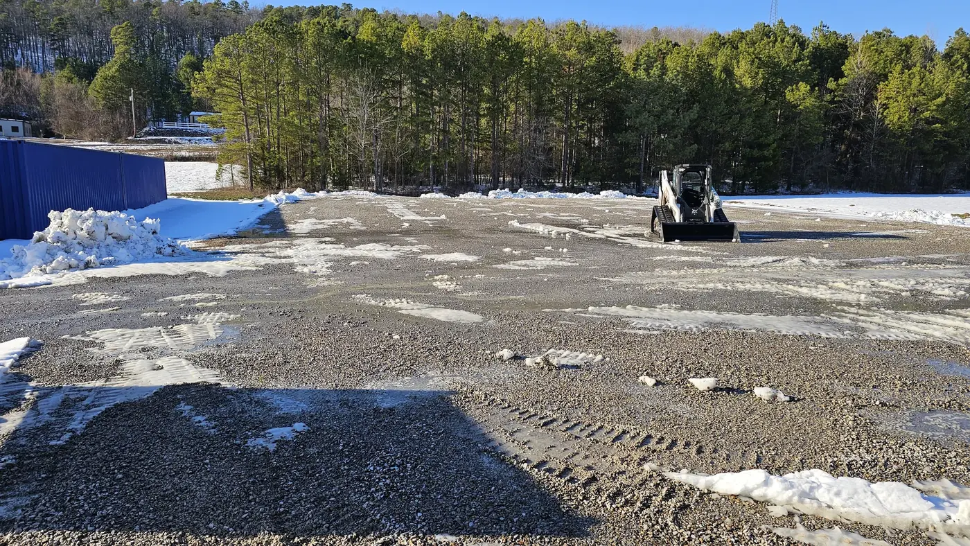 Gravel lot plowed clear of snow by Kingdom Land Services